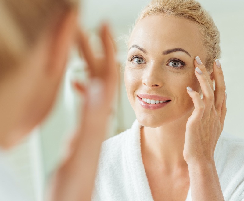 mature woman touching her face